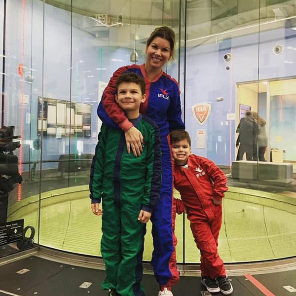 Explore family fun at Ocean City with kids in colorful jumpsuits at the skydiving simulator.